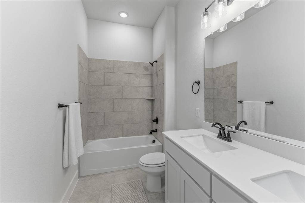 Contemporary bathroom featuring a dual-sink vanity with a white countertop and matte black fixtures