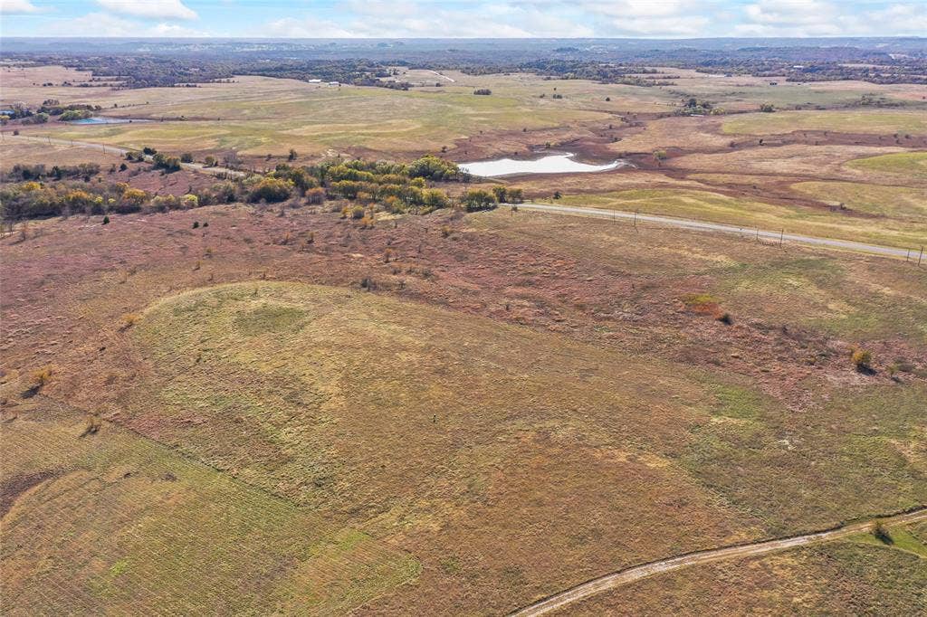 1315 Fm 677 S, Saint Jo, TX 76265 Aerial view of property and surrounding area with rural landscape and a large body of water