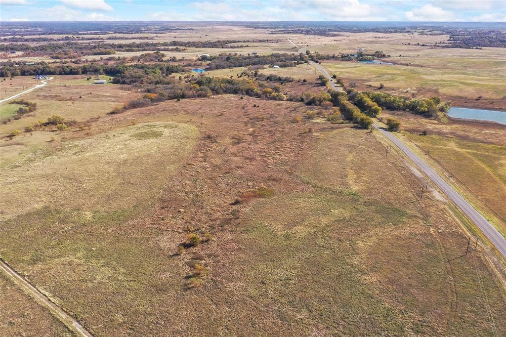 1315 Fm 677 S, Saint Jo, TX 76265 Aerial view of property's location with rural landscape and a nearby body of water