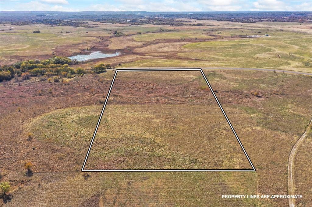 1315 Fm 677 S, Saint Jo, TX 76265 Overview of rural landscape featuring property parcel outlined and a nearby body of water