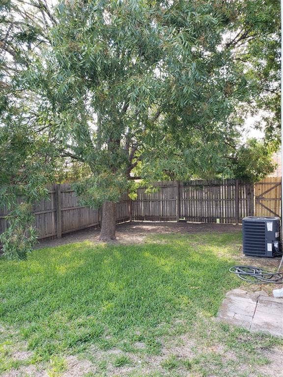 808-810 Red Bud Drive, DeSoto, TX 75115 808 - Fenced backyard with grass, and tree for shade.