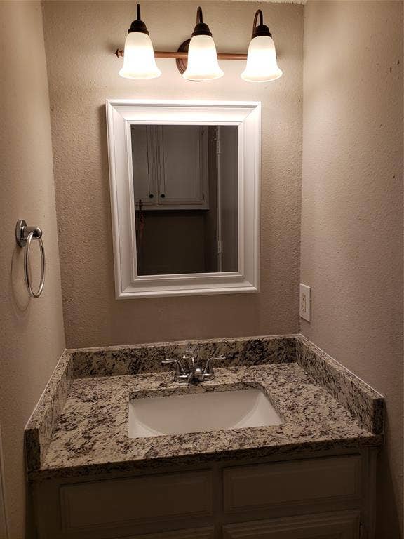 808-810 Red Bud Drive, DeSoto, TX 75115 808 - Downstairs vanity, sink, mirror, across from toilet; walkthrough to utility area.