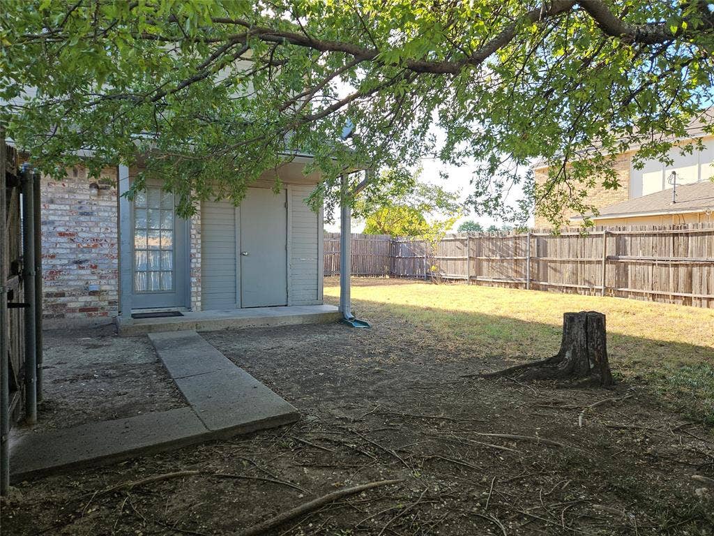 808-810 Red Bud Drive, DeSoto, TX 75115 810 - Fenced yard and back porch with storage closet.
