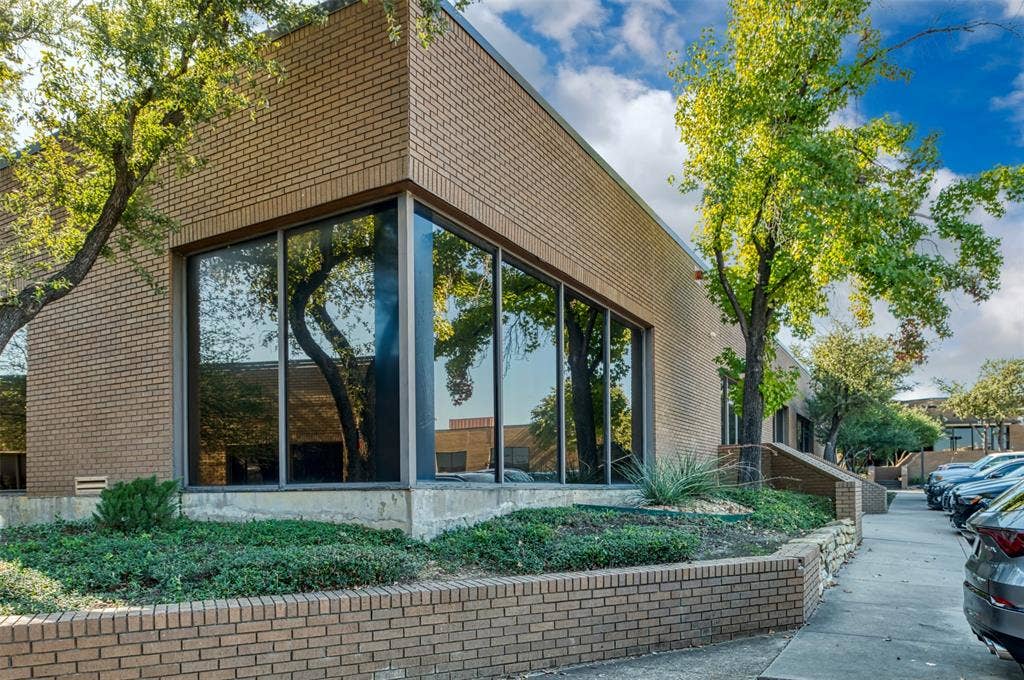 1610 Corporate Court, Irving, TX 75038 View of side of home with brick siding and a sunroom