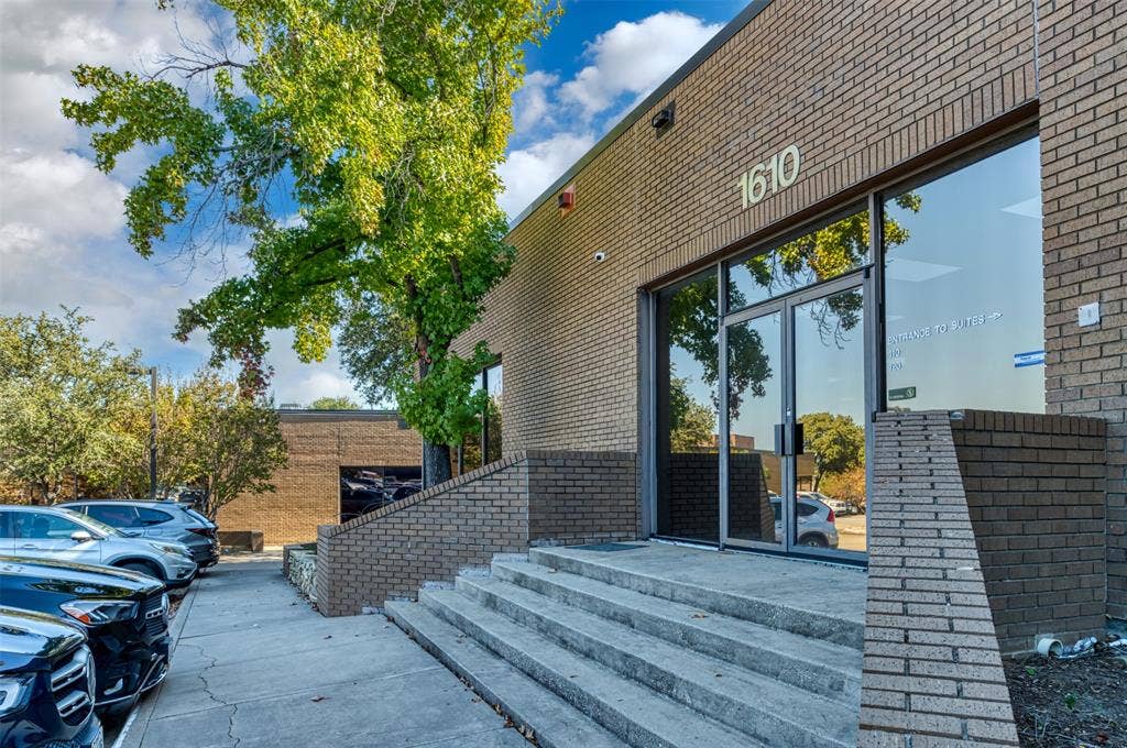 1610 Corporate Court, Irving, TX 75038 View of side of property with brick siding