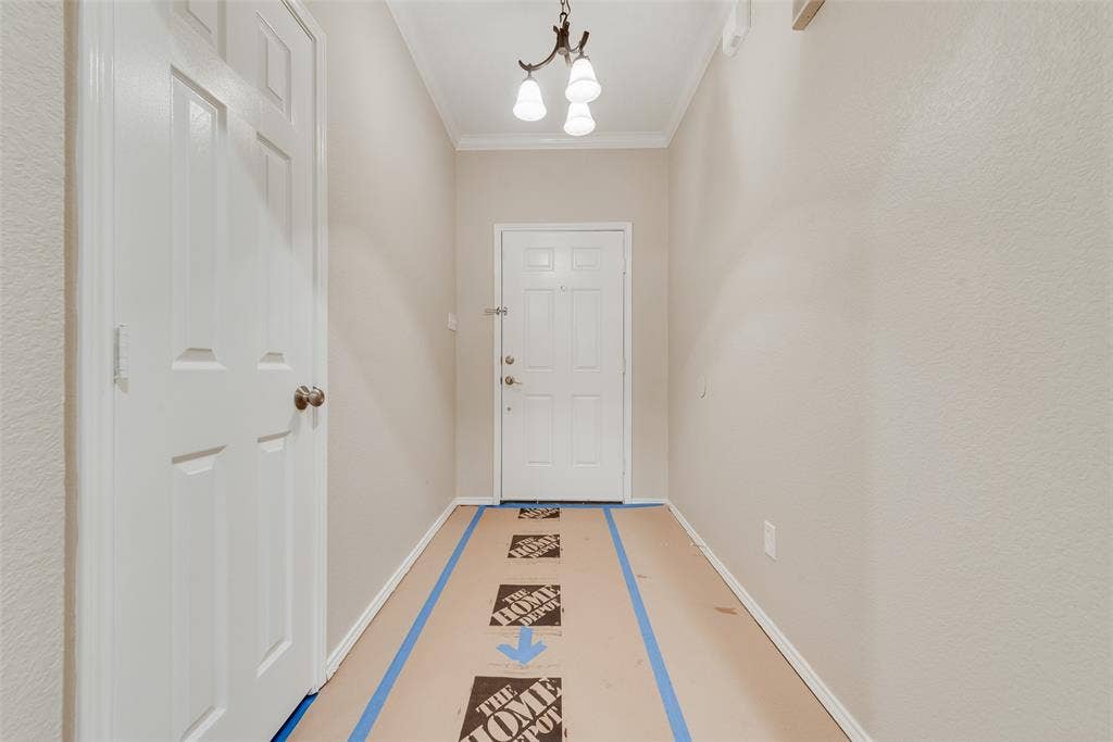 617 Madeline Court, Azle, TX 76020 Entryway with a chandelier and crown molding