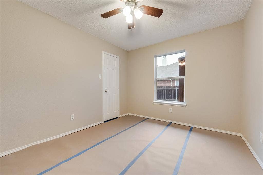 617 Madeline Court, Azle, TX 76020 Unfurnished room featuring a textured ceiling and a ceiling fan