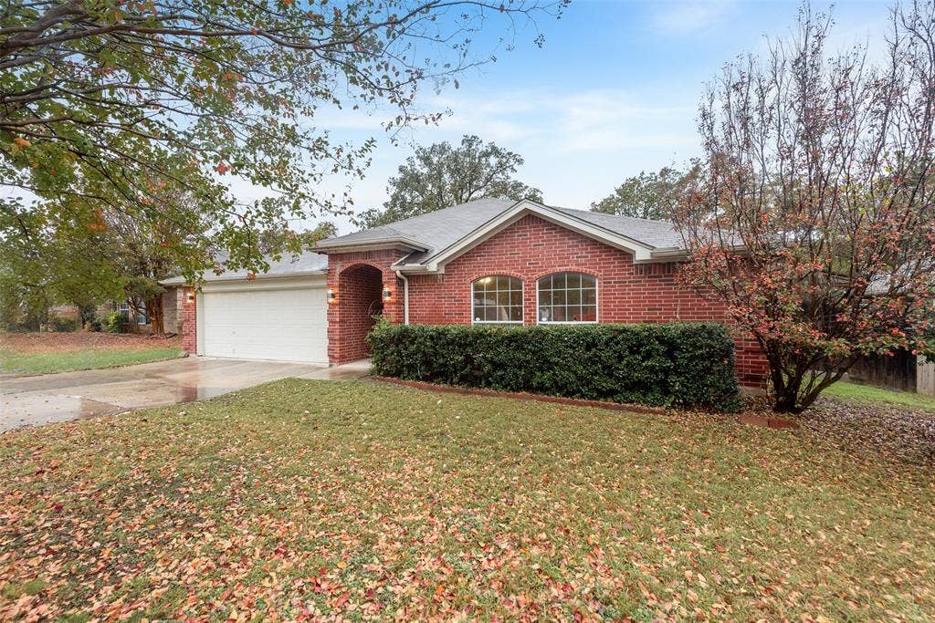 617 Madeline Court, Azle, TX 76020 Single story home featuring driveway, brick siding, a front lawn, and a garage