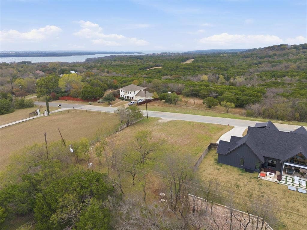 13854 Harbor Drive, Woodway, TX 76712 View of subject property with a forest