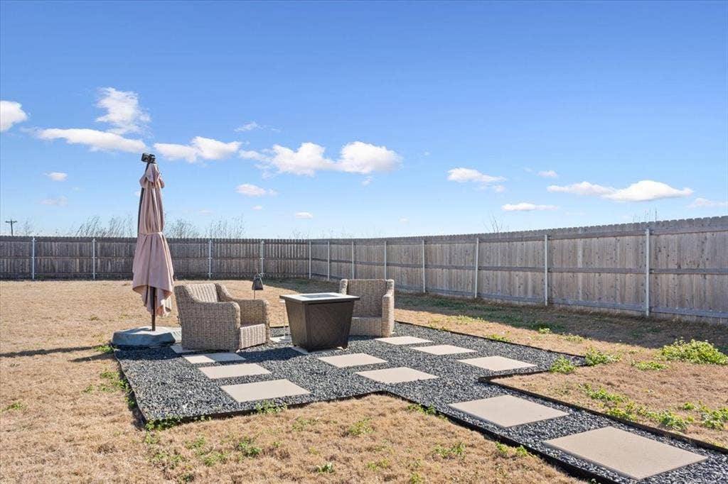 518 Alamo Court, McGregor, TX 76657 Fenced backyard with a patio