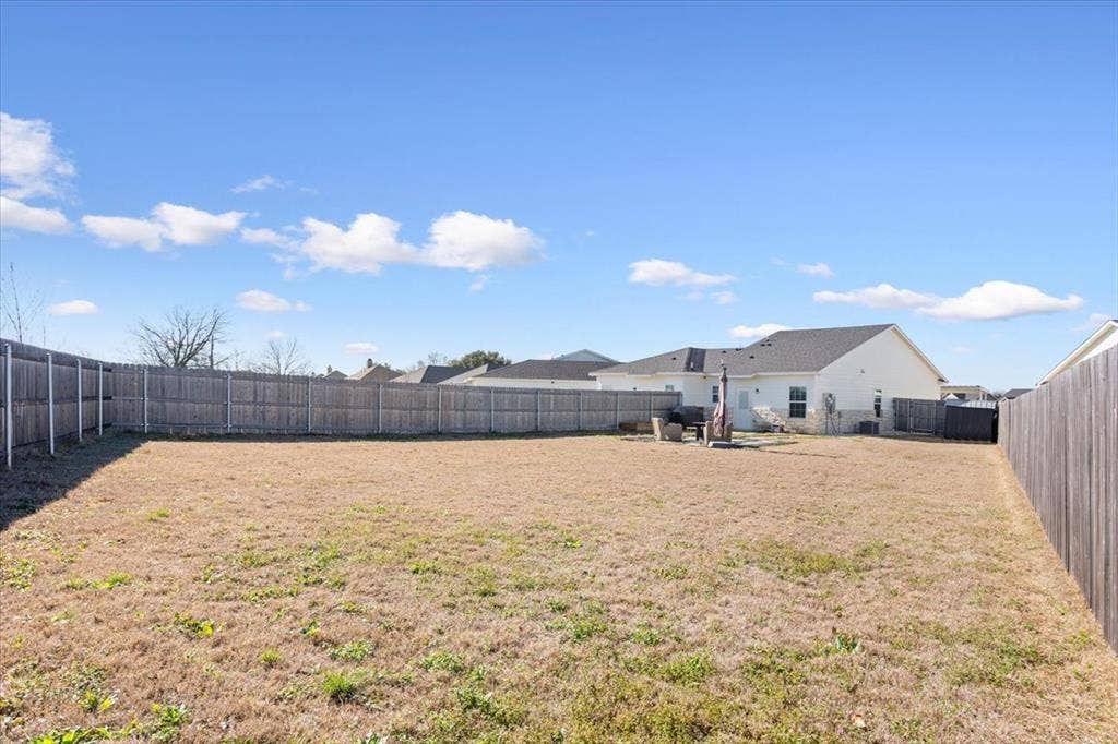 518 Alamo Court, McGregor, TX 76657 Fenced backyard featuring a patio area