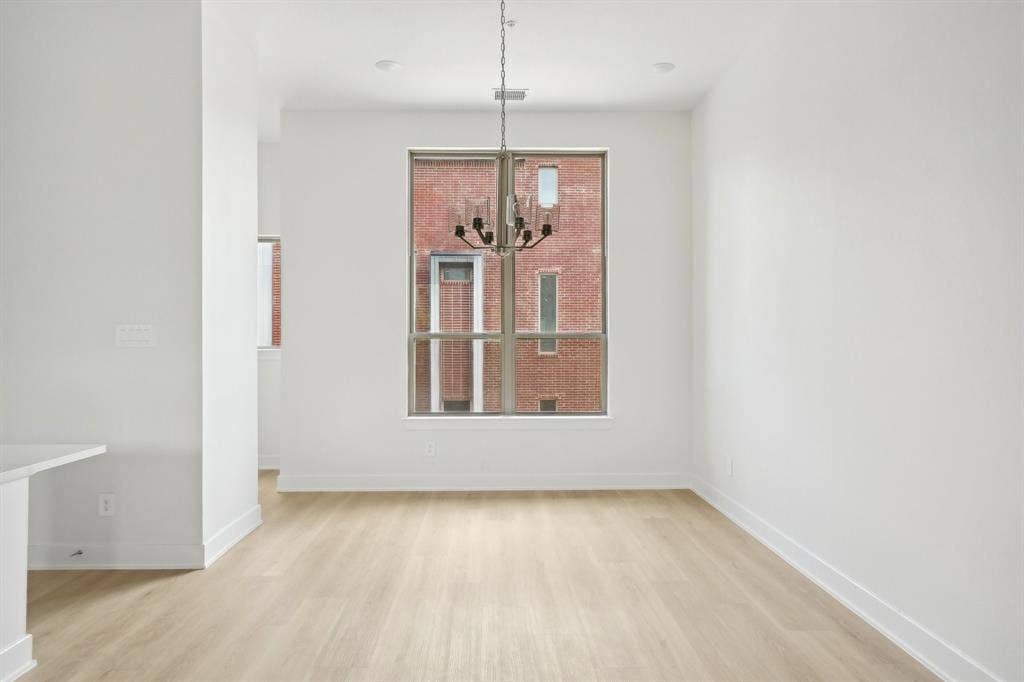 2524 Havenhurst Street, #102, Farmers Branch, TX 75234 Unfurnished dining area featuring light wood-style floors and a chandelier