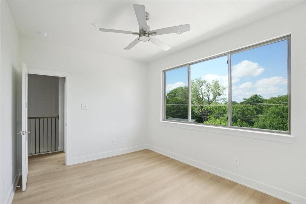 2524 Havenhurst Street, #102, Farmers Branch, TX 75234 Unfurnished room with light wood-style floors and a ceiling fan