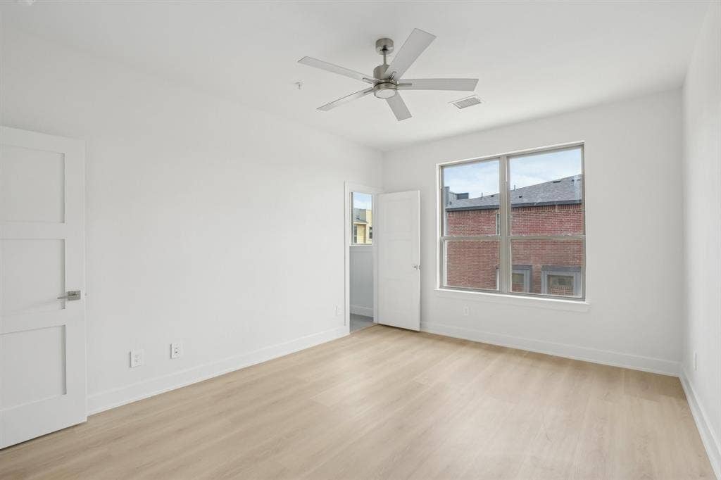 2524 Havenhurst Street, #102, Farmers Branch, TX 75234 Empty room featuring light wood-style floors and a ceiling fan