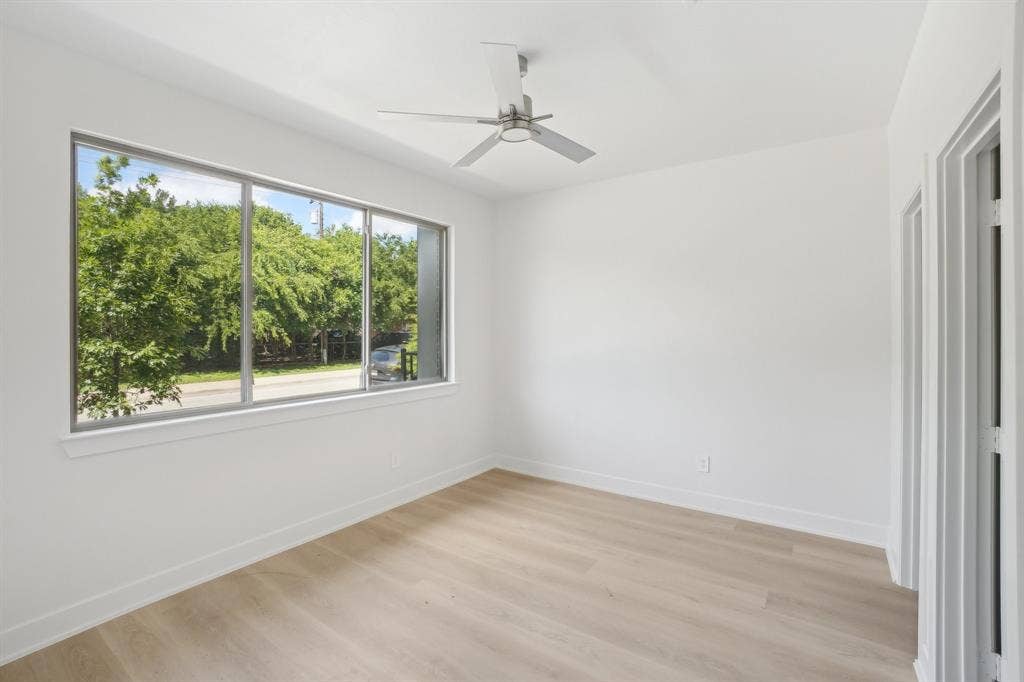 2524 Havenhurst Street, #102, Farmers Branch, TX 75234 Empty room featuring light wood finished floors and a ceiling fan