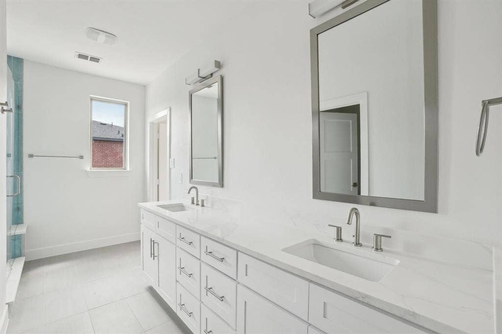 2524 Havenhurst Street, #102, Farmers Branch, TX 75234 Bathroom with double vanity, a stall shower, and light tile patterned flooring