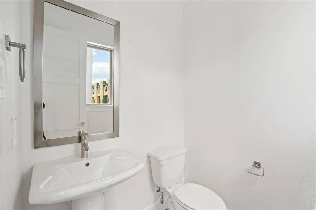 2524 Havenhurst Street, #102, Farmers Branch, TX 75234 Half bathroom with a sink and toilet