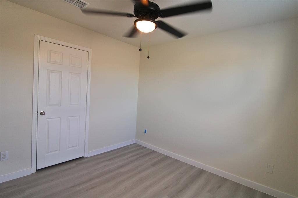 Unfurnished bedroom featuring light wood-type flooring and ceiling fan