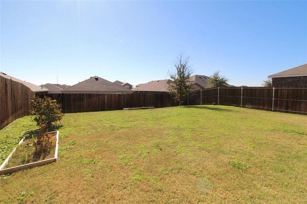 View of fenced backyard