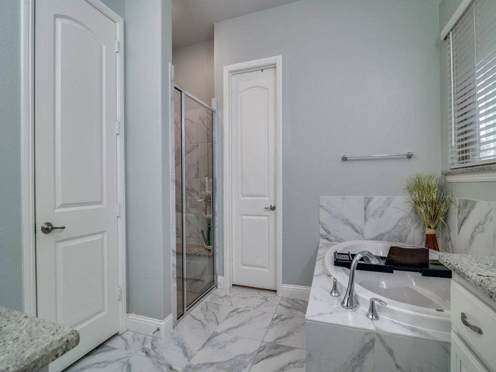 918 Colby Bluff Drive, Rockwall, TX 75087 Separate shower and walk-in closet with closet system