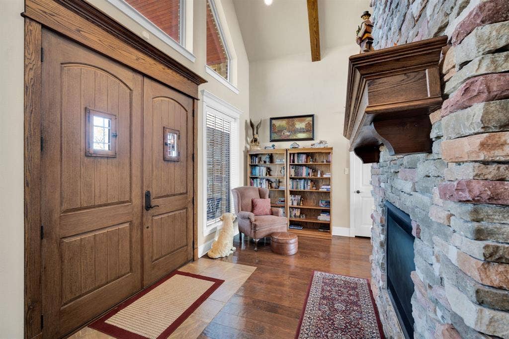 217 Hunter Pass, Waxahachie, TX 75165 Foyer featuring high vaulted ceiling, dark wood-style floors, a stone fireplace, and beamed ceiling