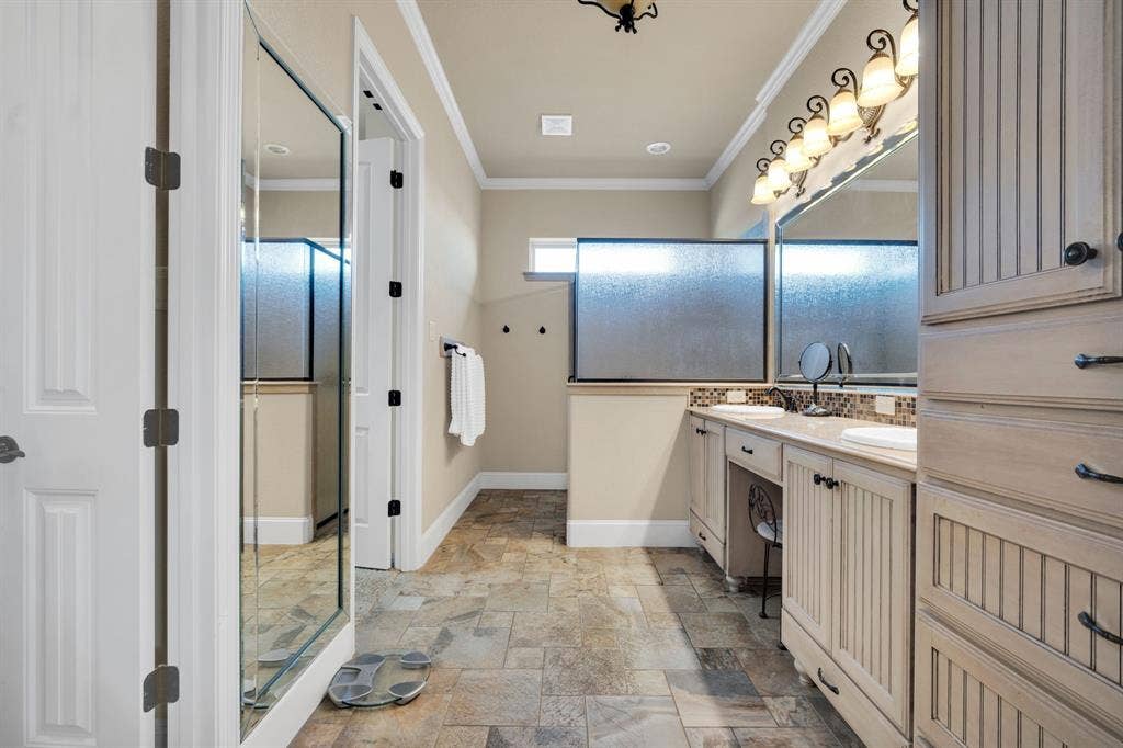 217 Hunter Pass, Waxahachie, TX 75165 Full bath featuring crown molding, double vanity, and stone tile floors