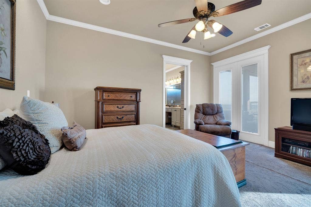 217 Hunter Pass, Waxahachie, TX 75165 Carpeted bedroom featuring ornamental molding, a ceiling fan, and ensuite bathroom