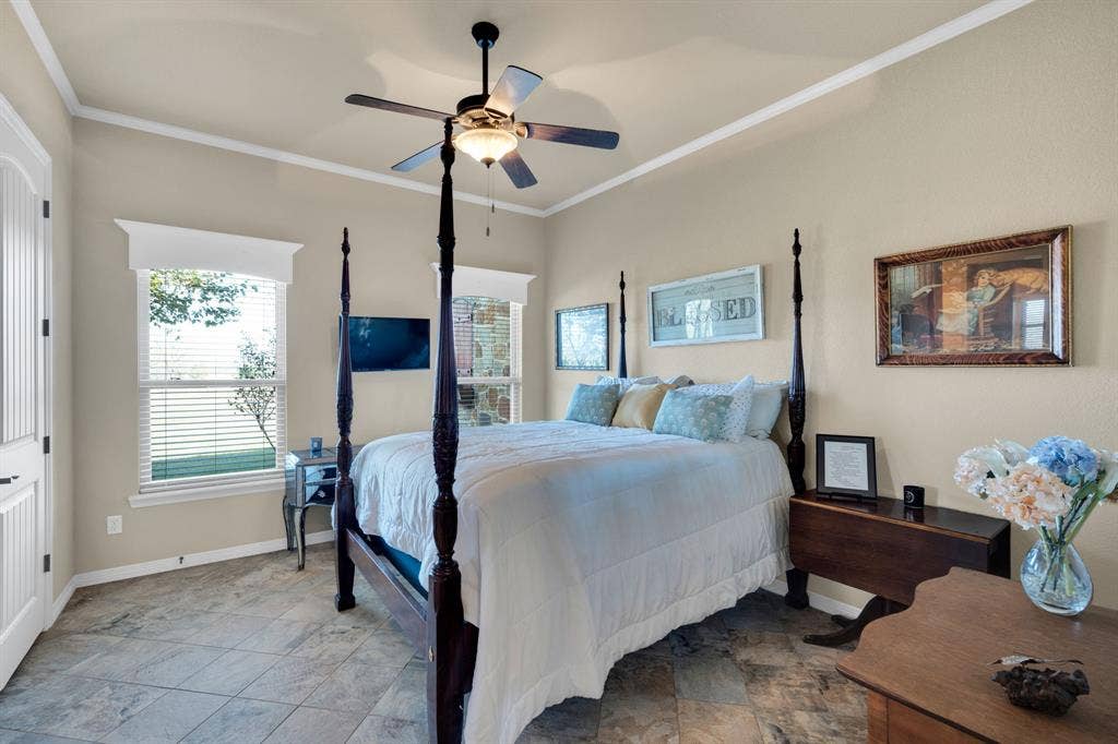 217 Hunter Pass, Waxahachie, TX 75165 Bedroom featuring crown molding, multiple windows, and a ceiling fan