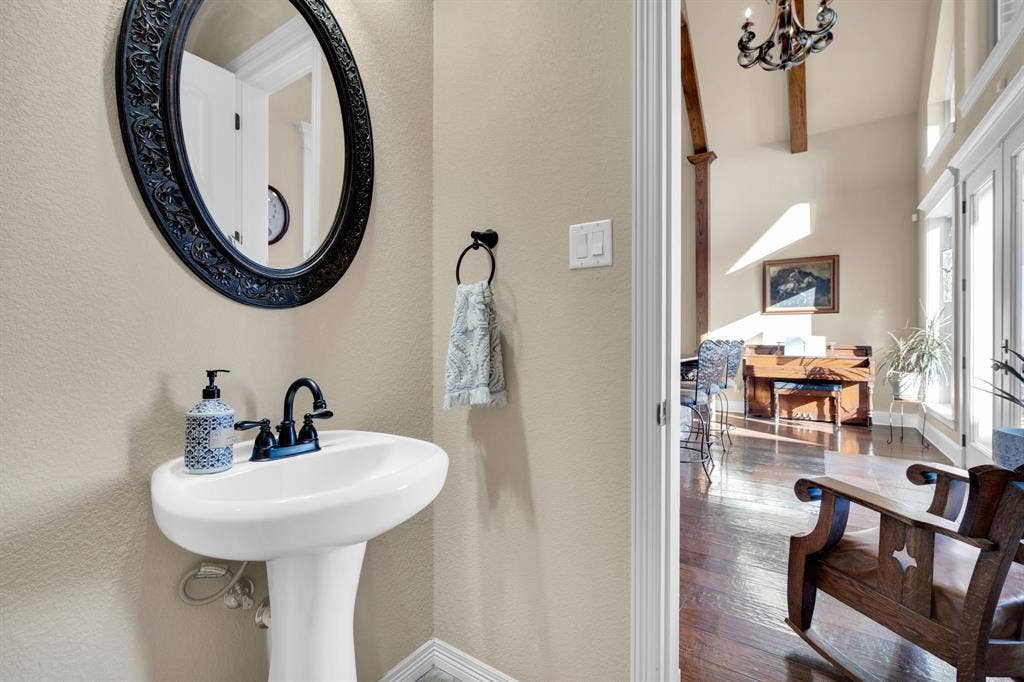 217 Hunter Pass, Waxahachie, TX 75165 Bathroom with a chandelier, dark wood-type flooring, a textured wall, and beamed ceiling