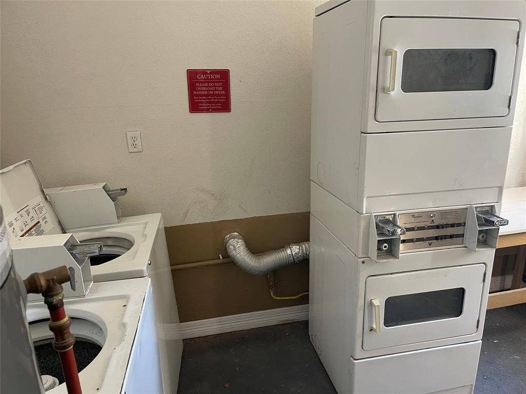 322 S Waco Street, Weatherford, TX 76086 Shared laundry with baseboards and stacked washer / dryer