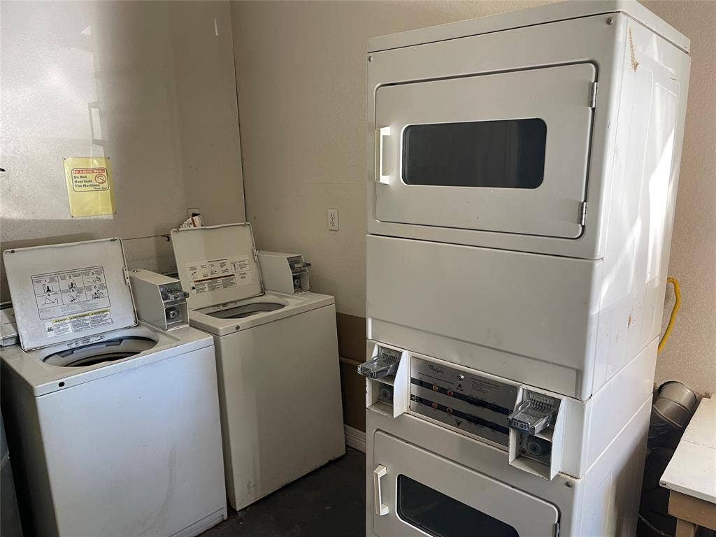 322 S Waco Street, Weatherford, TX 76086 Communal laundry room with stacked washer and clothes dryer