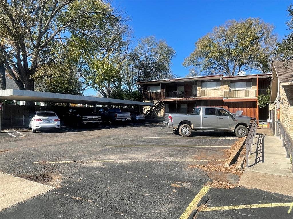 322 S Waco Street, Weatherford, TX 76086 Partially covered parking lot featuring stairway