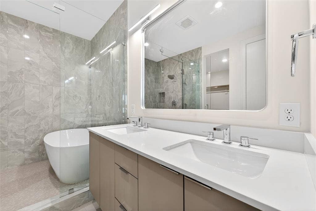 6603 Roper Street, Dallas, TX 75209 Primary bathroom features double sinks and spacious wet room with freestanding tub.