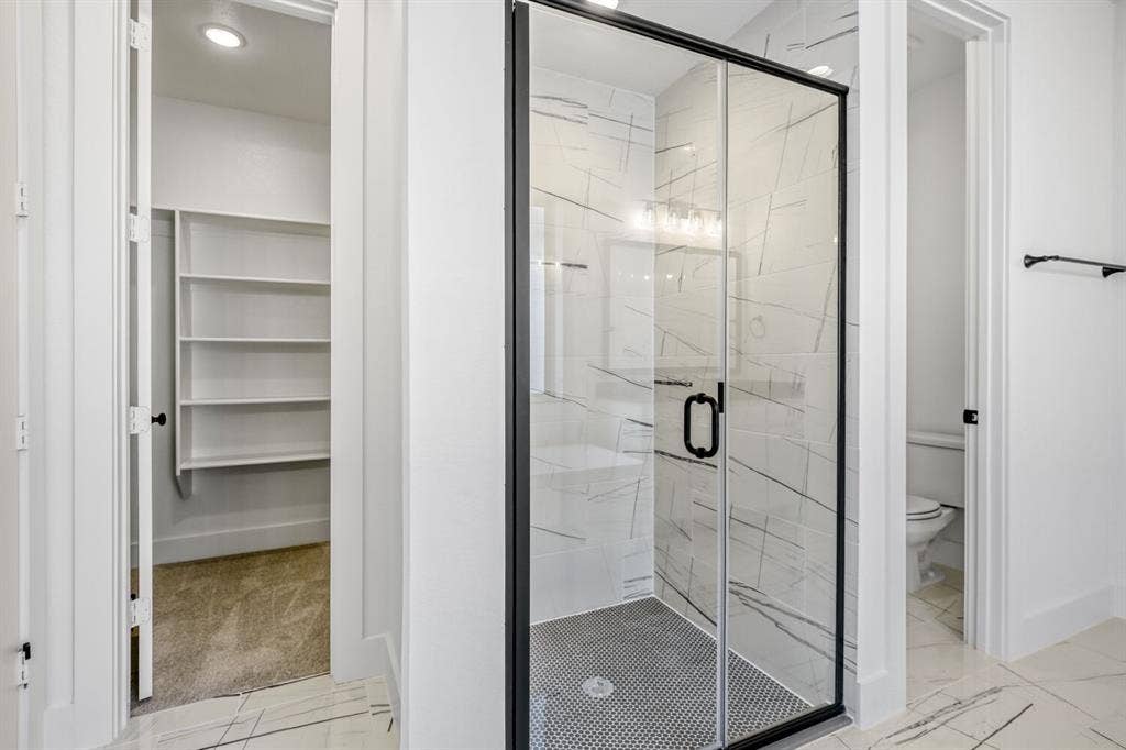 2228 Prickly Cactus Drive, Forney, TX 75126 Full bath with a marble finish shower, light marble finish flooring, and a spacious closet