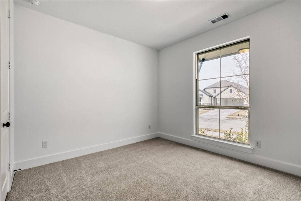 2228 Prickly Cactus Drive, Forney, TX 75126 Empty room with light colored carpet and baseboards