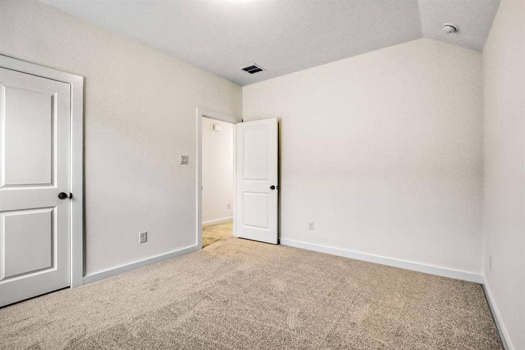 2228 Prickly Cactus Drive, Forney, TX 75126 Unfurnished bedroom with carpet and lofted ceiling