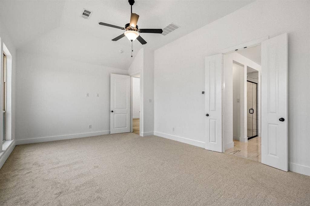 2228 Prickly Cactus Drive, Forney, TX 75126 Unfurnished bedroom with light colored carpet, lofted ceiling, and ceiling fan