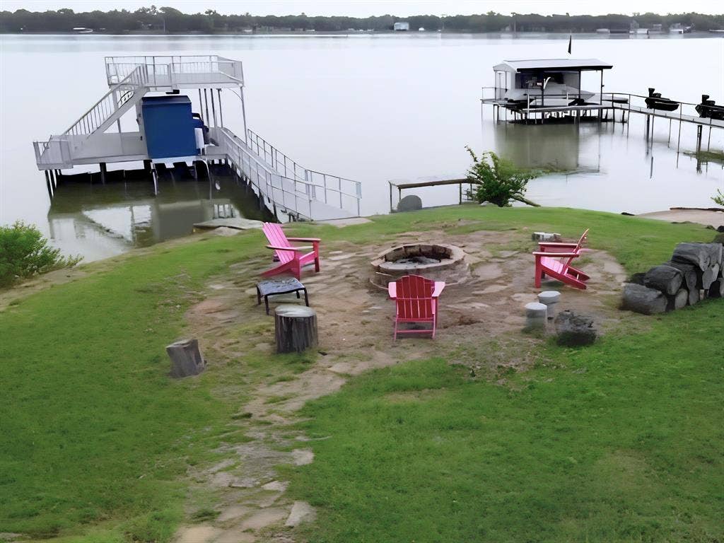 7130 Briar Road, Azle, TX 76020 Lakeside property featuring a stone fire pit area with flagstone paving