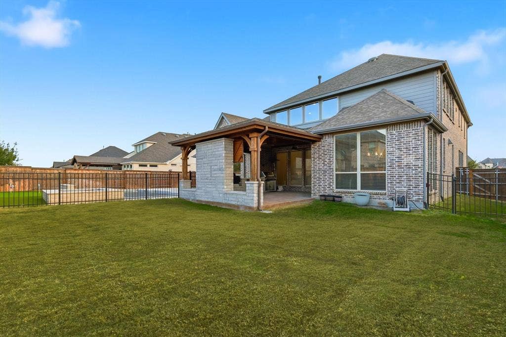 3860 Dewberry Lane, Prosper, TX 75078 Back of home as you can see some grass is still left the other side is turf