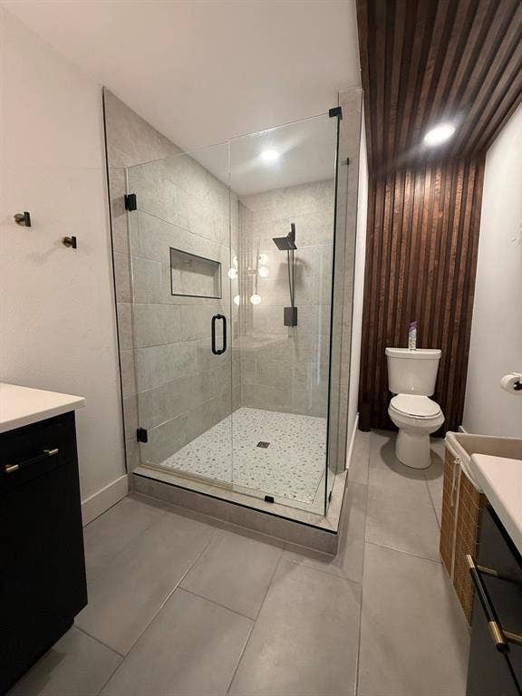 Full bathroom featuring vanity, a shower stall, and light tile patterned floors