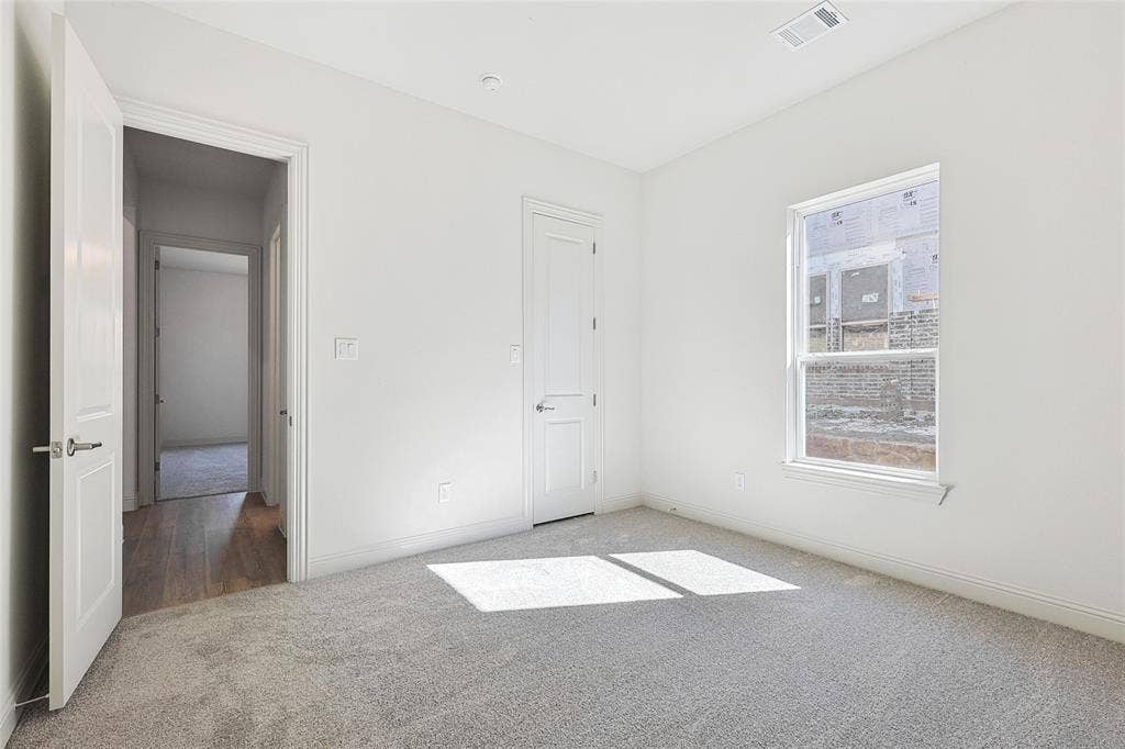 313 Trinity Court, Shady Shores, TX 76208 Unfurnished bedroom with carpet and baseboards