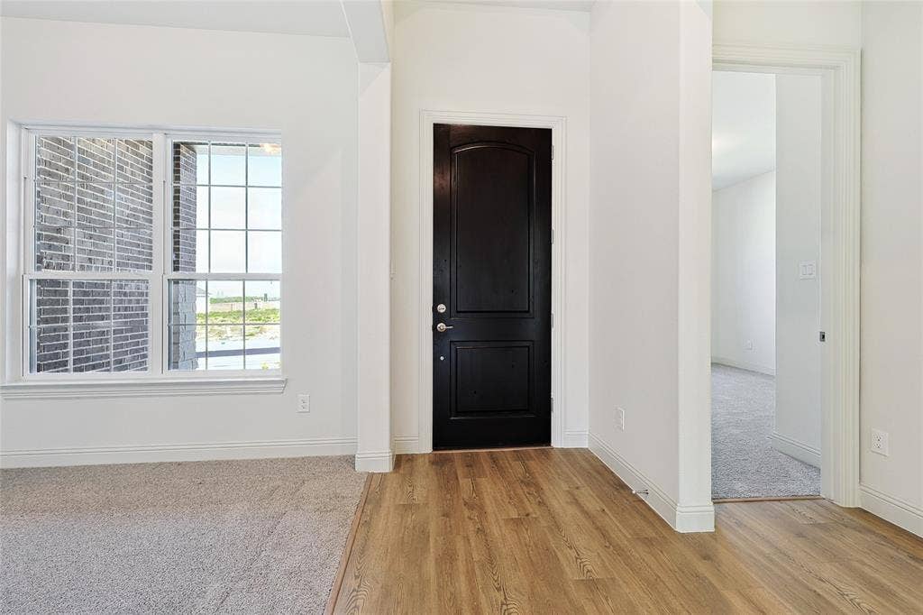 313 Trinity Court, Shady Shores, TX 76208 Entrance foyer with light wood-style flooring and baseboards