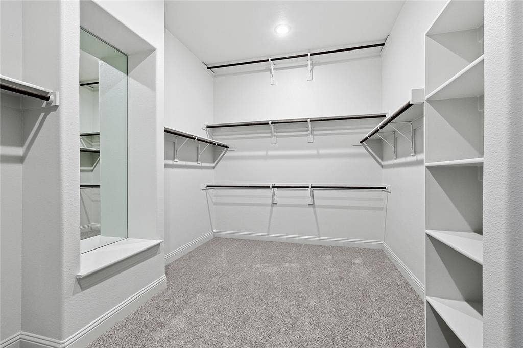 313 Trinity Court, Shady Shores, TX 76208 Walk in closet featuring light colored carpet