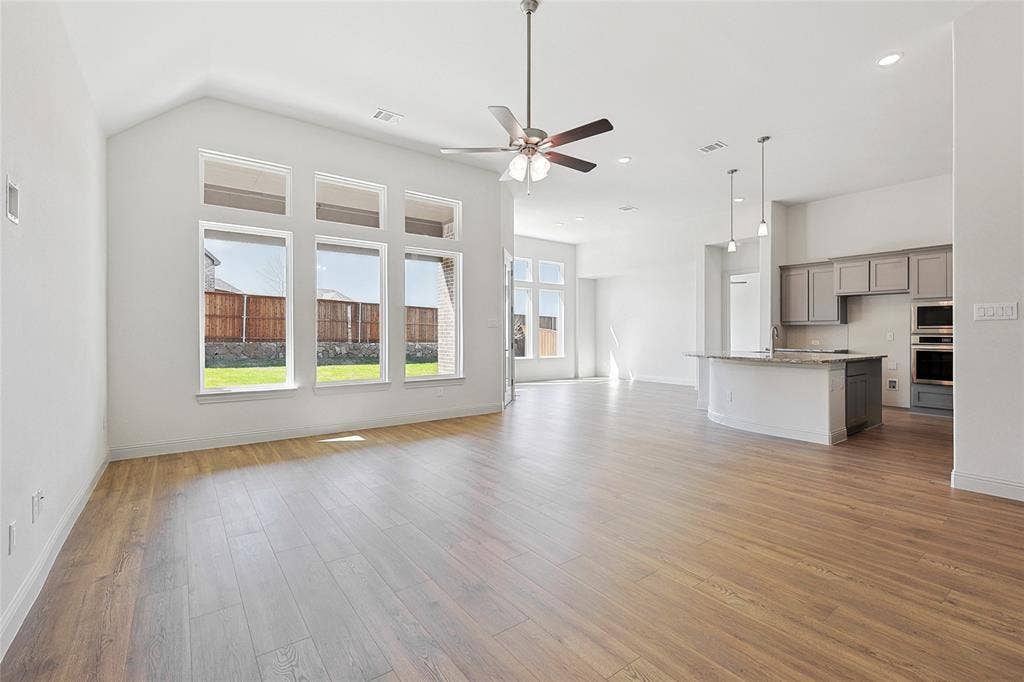 313 Trinity Court, Shady Shores, TX 76208 Unfurnished living room with a ceiling fan, light wood-style flooring, and high vaulted ceiling