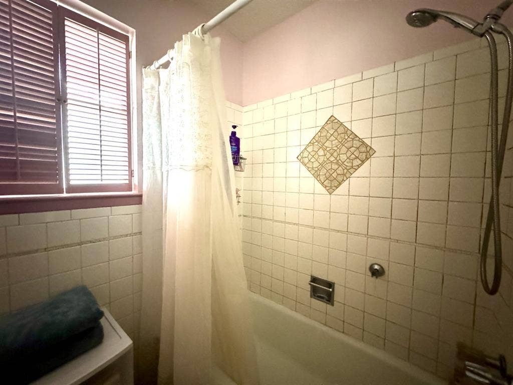 317 N Trail Street, Crowley, TX 76036 Full bath featuring shower / bath combo and tile walls
