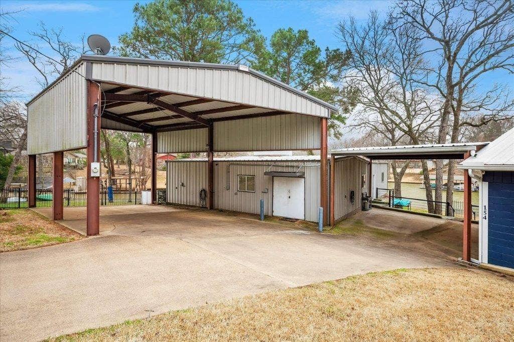 154 Bayside Circle, Malakoff, TX 75148 RV covered parking with electric and water hook up. Metal building and 2 car carport.