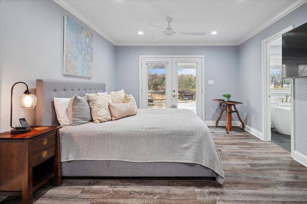 154 Bayside Circle, Malakoff, TX 75148 Primary bedroom with private balcony with beautiful elevated water views, Huge master walk in closet with built ins.