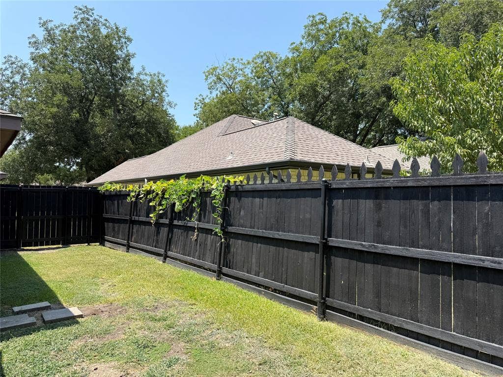 6018 Raleigh Drive, Garland, TX 75044 Fenced backyard with established lawn and mature trees