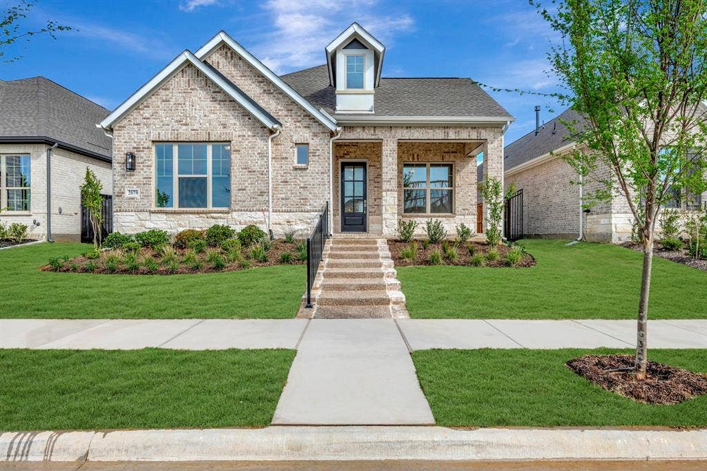 2079 Emerald Grove Lane, Arlington, TX 76005 View of front of house featuring a front lawn, a porch, roof with shingles, brick siding, and stone siding