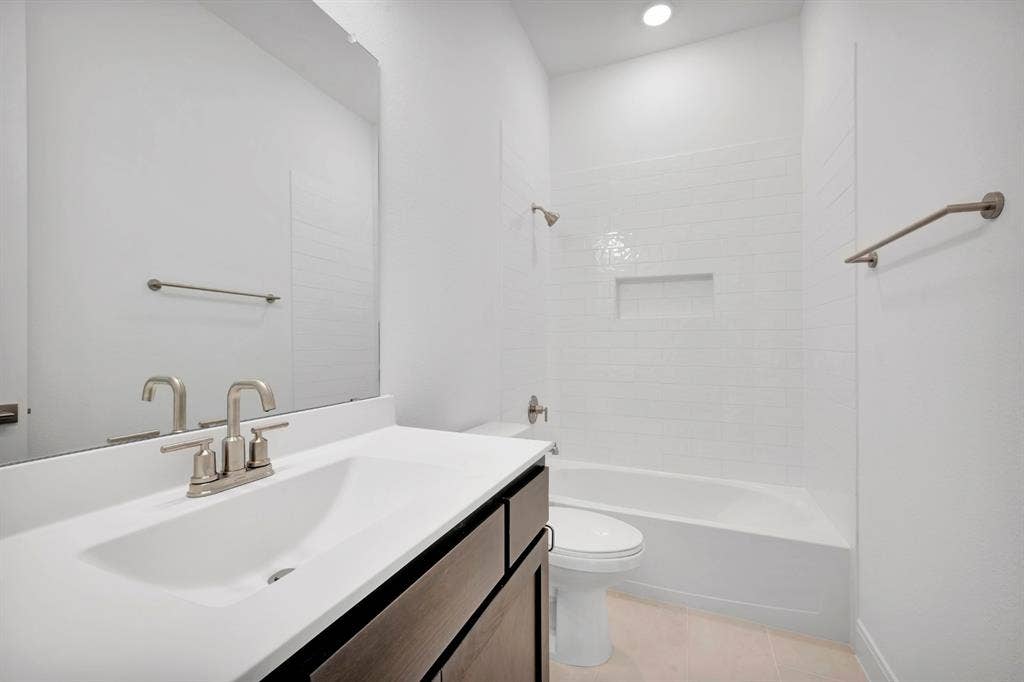 2079 Emerald Grove Lane, Arlington, TX 76005 Full bathroom featuring vanity, shower combination, light tile patterned flooring, and recessed lighting